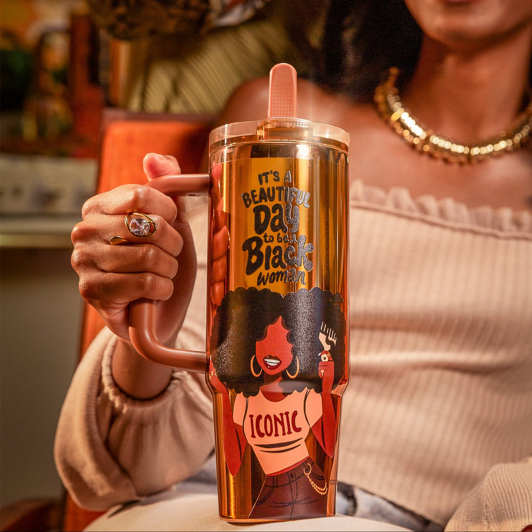Copper Luxe HydraLock tumbler with an illustrated Black woman lifting her full afro with a pick, wearing gold hoops and a white crop top reading ICONIC, beneath the black affirmation It's a Beautiful Day to Be a Black Woman